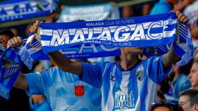 Un aficionado con una bufanda del Málaga CF.