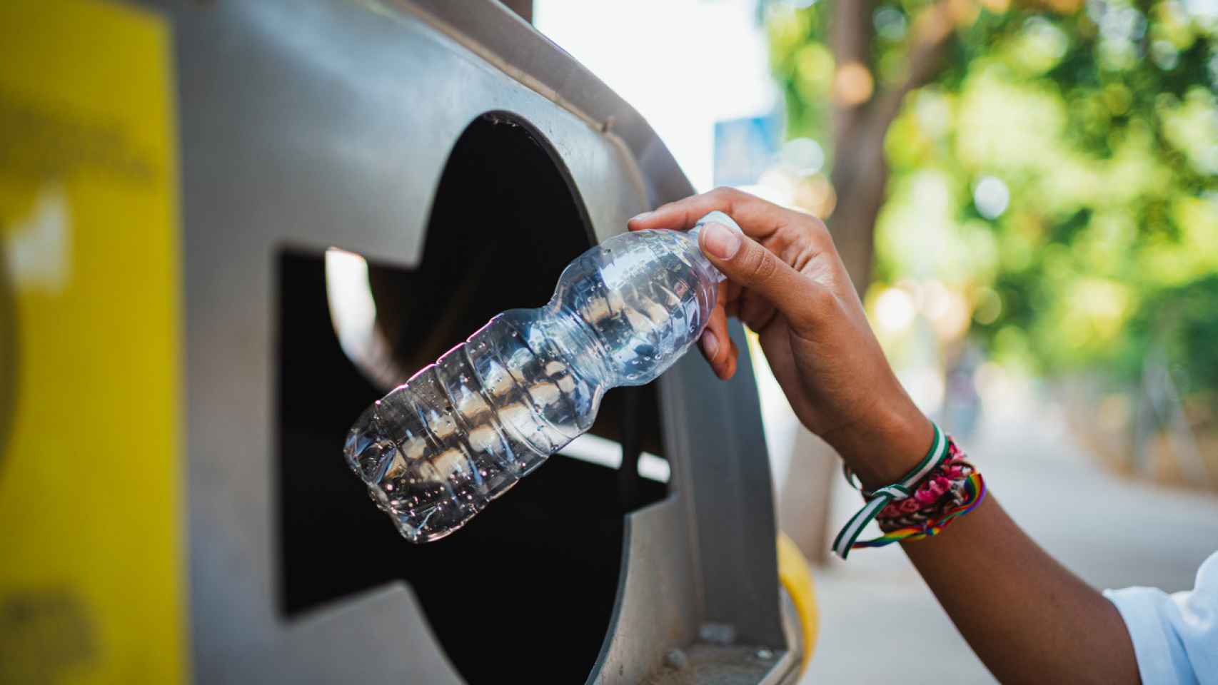 Imagen de archivo de una mujer reciclando una botella de plástico.