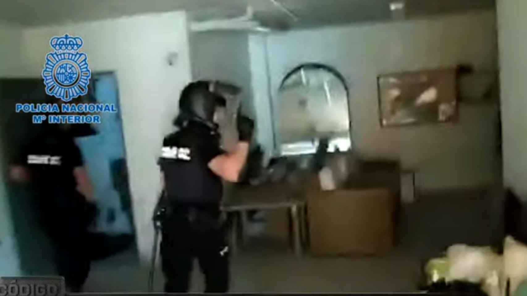 Dos policías nacionales durante el registro de la casa-club Viviane de Alcantarilla.