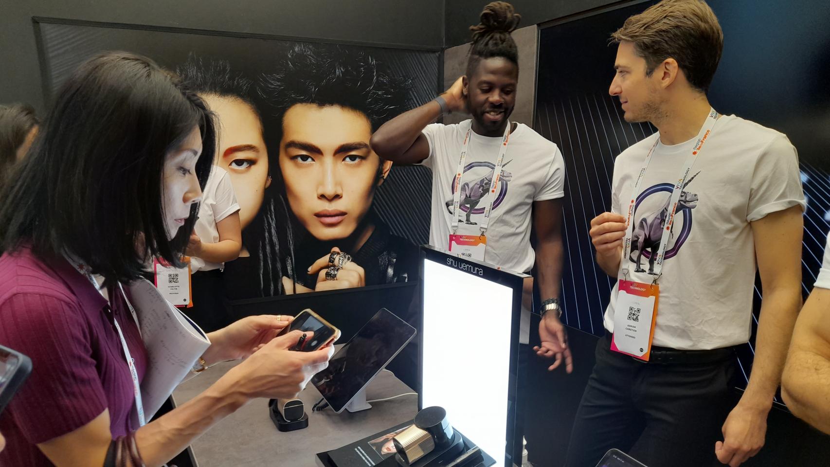 Visitantes en el stand de L'Oréal en VivaTech 2023 contemplan la solución tecnológica 3D Shu:Brow de Shu Uemura, concebida para lograr un look profesional de cejas en casa.
