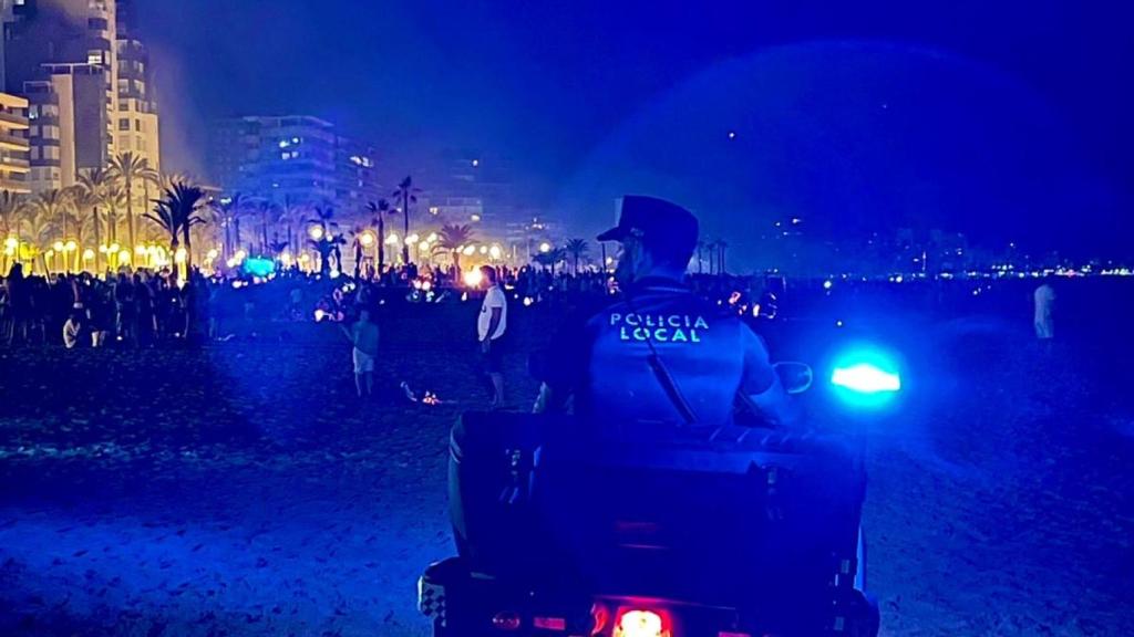 Un agente de Policía Local controlando una playa de Alicante en una noche de San Juan, en imagen de archivo.