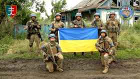 Militares ucranianos posan con la bandera ucraniana en el pueblo liberado de Storozheve, en la región de Dontesk.