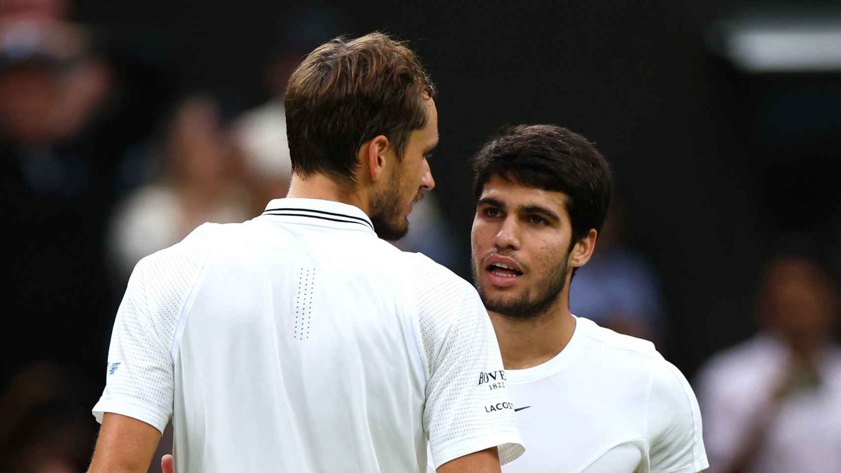 Abrazo entre Carlos Alcaraz y Daniil Medvedev tras la semifinal de Wimbledon 2023
