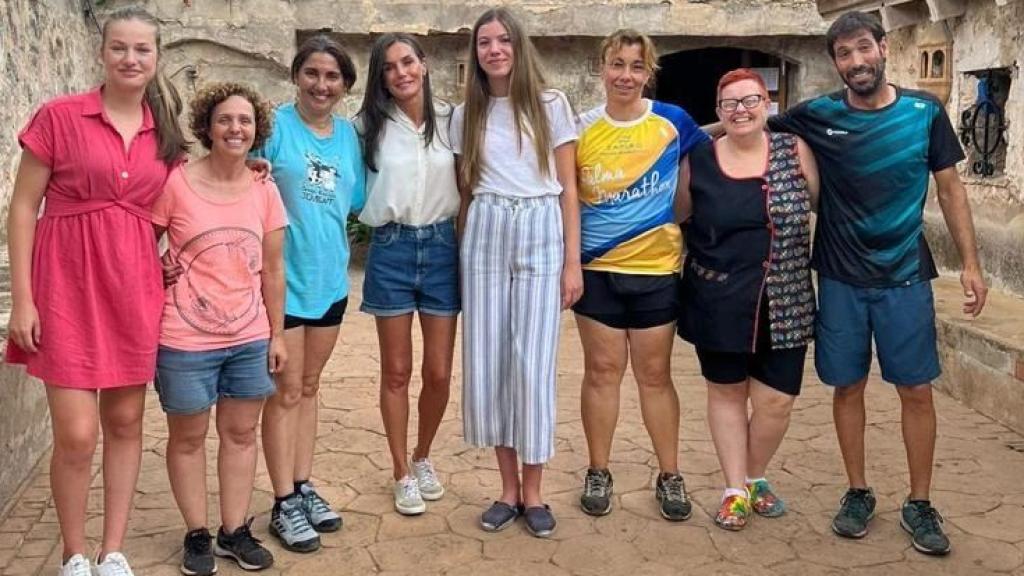 La Reina y sus hijas posando con los profesionales de la granja escuela Jovent.