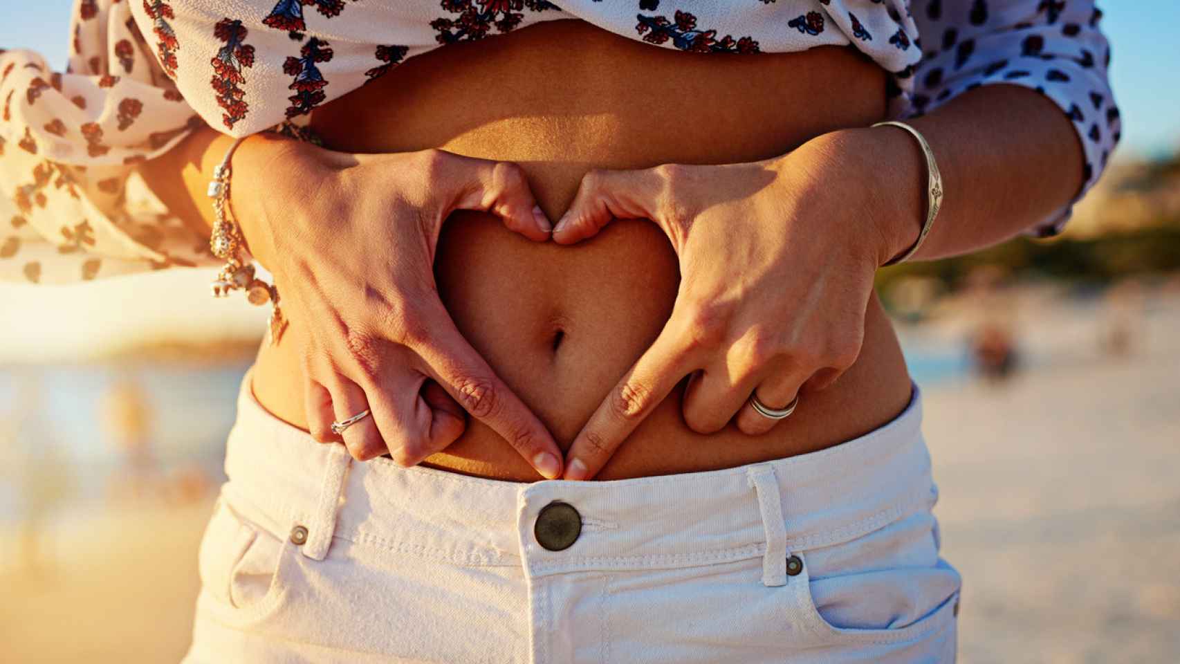 Imagen de archivo de una mujer con sus manos en el abdomen. Foto: iStock.