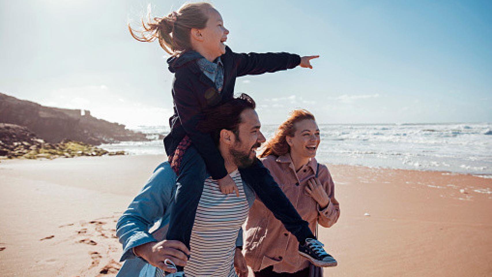 Familia feliz en la playa. Foto: Getty Images.