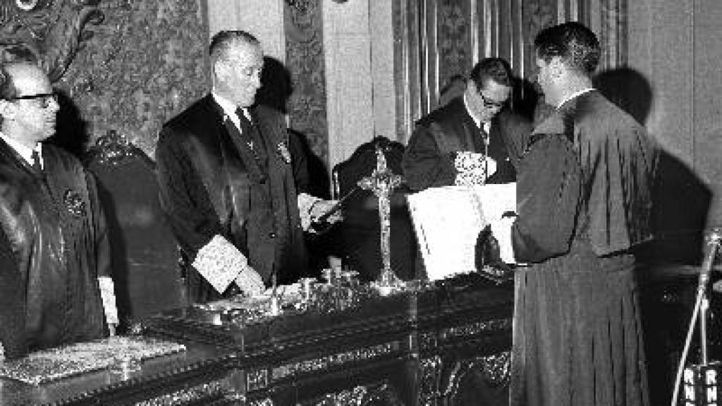 José Francisco Mateu Cánovas (de espaldas) escucha al secretario durante su toma de posesión como presidente del TOP, en 1968