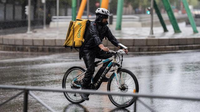 Un repartidor trabaja bajo la lluvia, a 3 de septiembre de 2023, en Madrid.