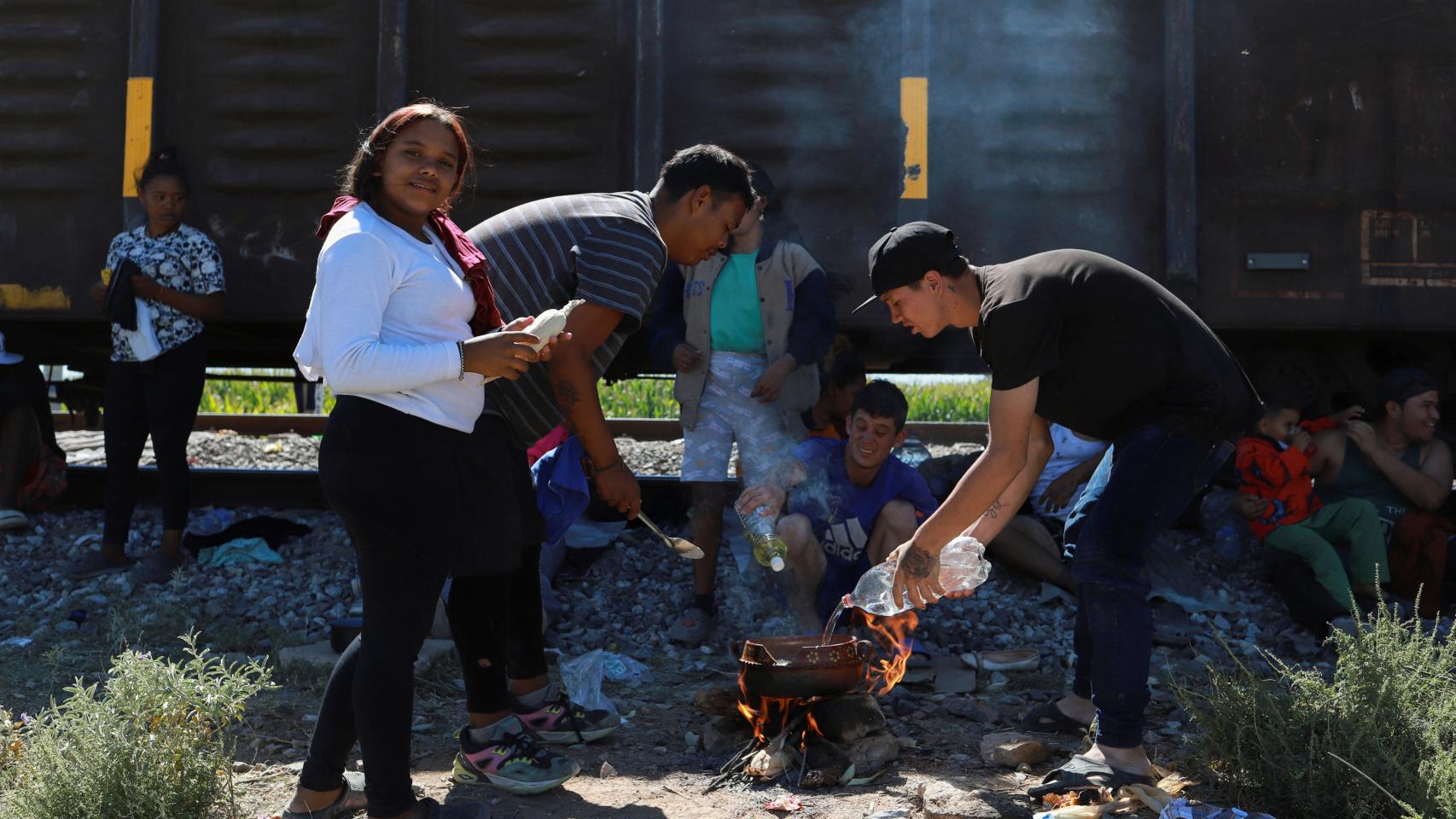 Migrantes junto a uno de los trenes parados cerca de la frontera con EEUU