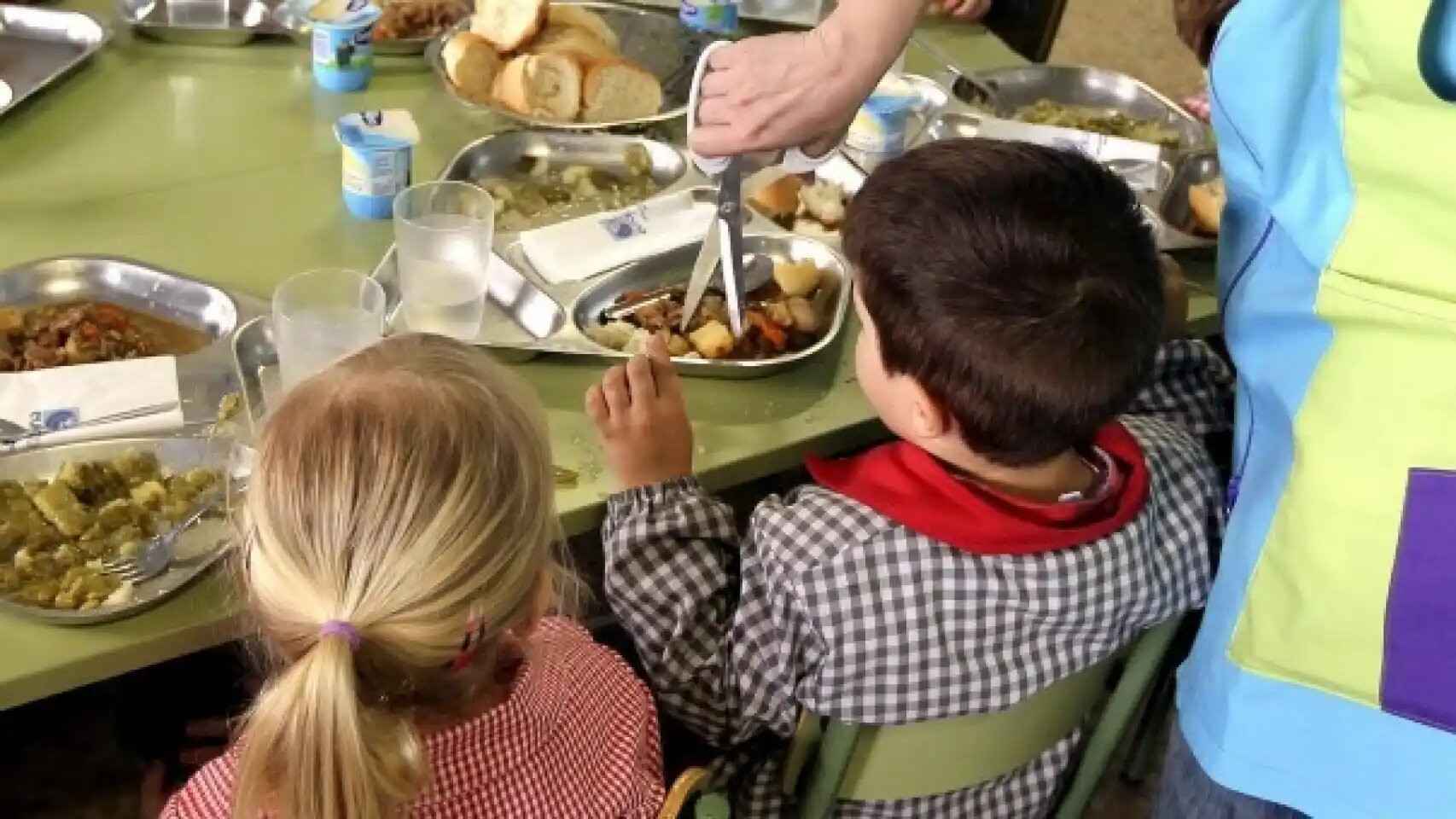 Unos niños comiendo en un comedor escolar