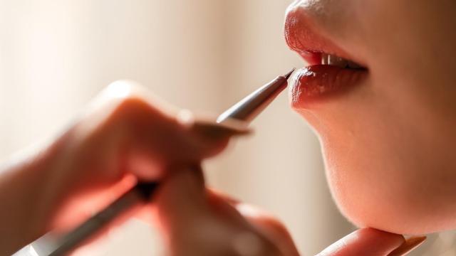 Mujer pintándose los labios