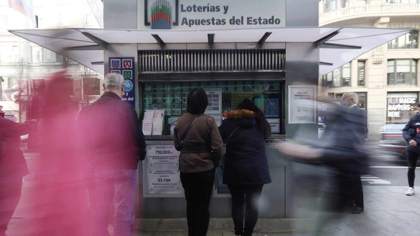 Varias personas en las inmediaciones de una administración de lotería.