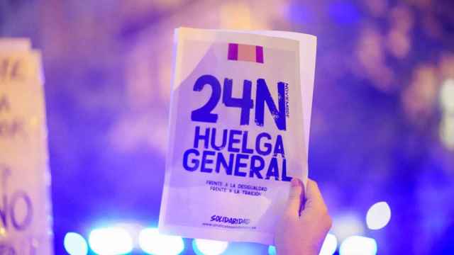 Una persona levanta un panfleto con la convocatoria a la huelga general del sindicato de Vox durante la manifestación en Ferraz.