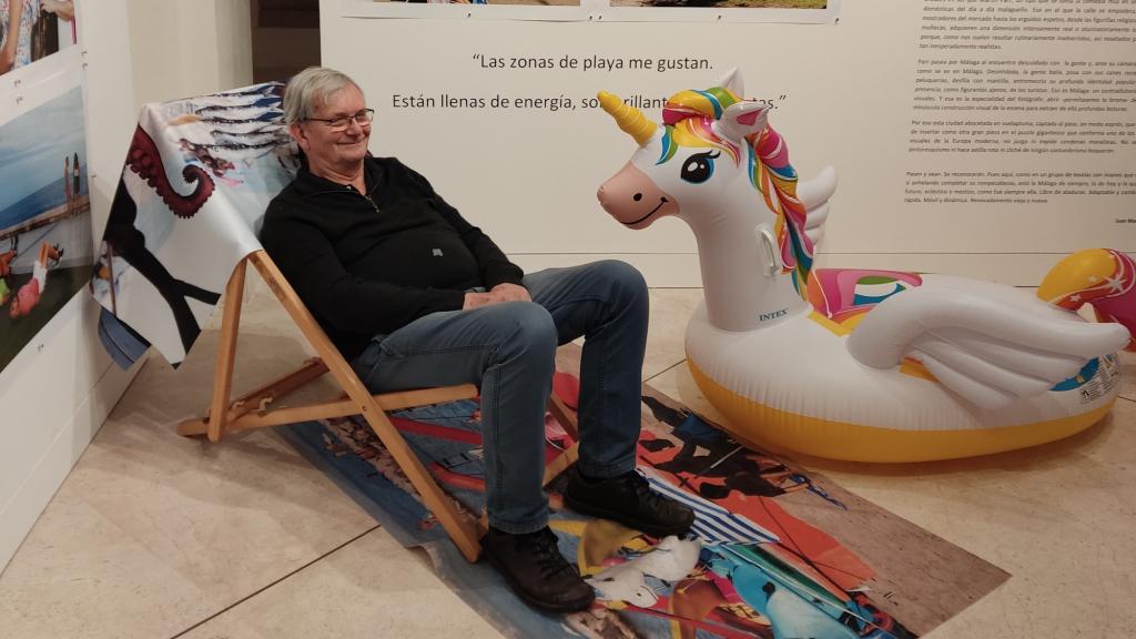 Martin Parr, sentado en una hamaca de playa en su exposición.