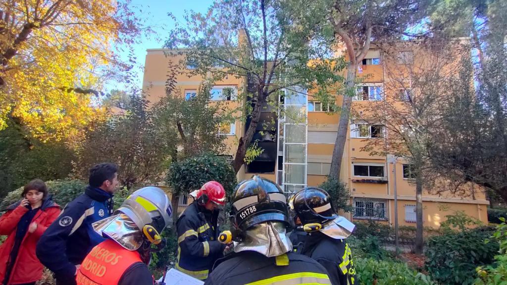 Los bomberos, frente al edificio que ha sufrido un incendio en San Blas.