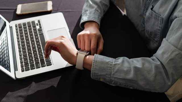 Imagen de un escritorio y una persona con un smartwatch