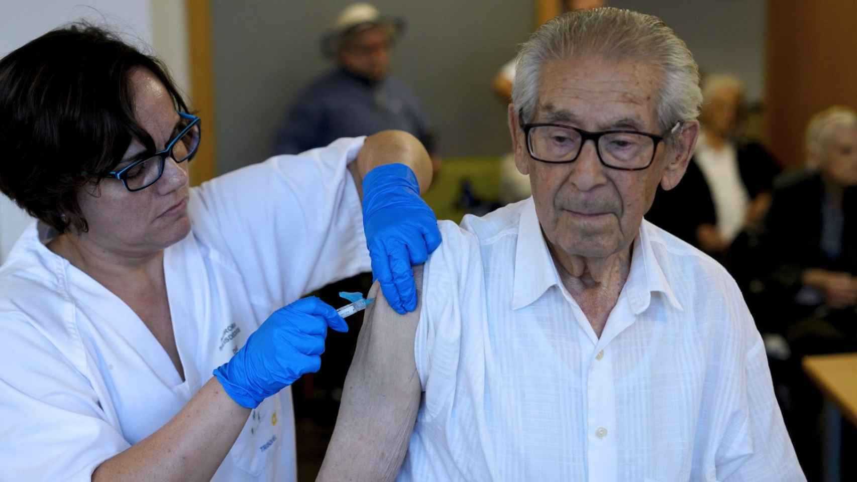 Un hombre recibe la vacuna de la gripe.