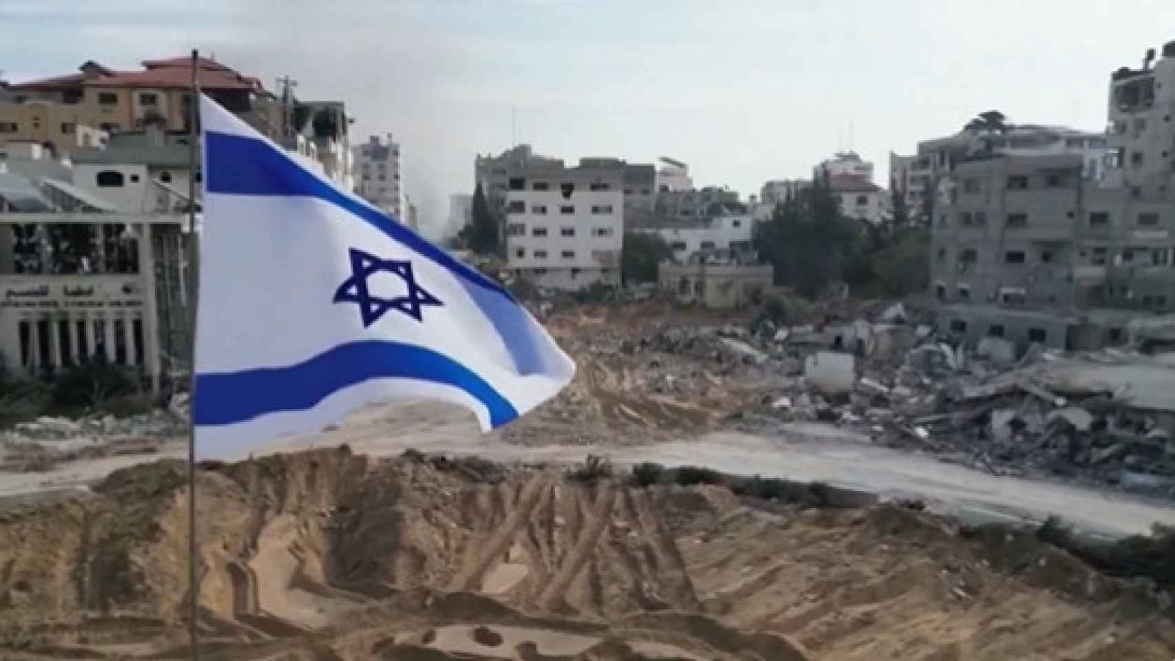 Una bandera israelí colocada en la destruida Plaza Palestina en Gaza.
