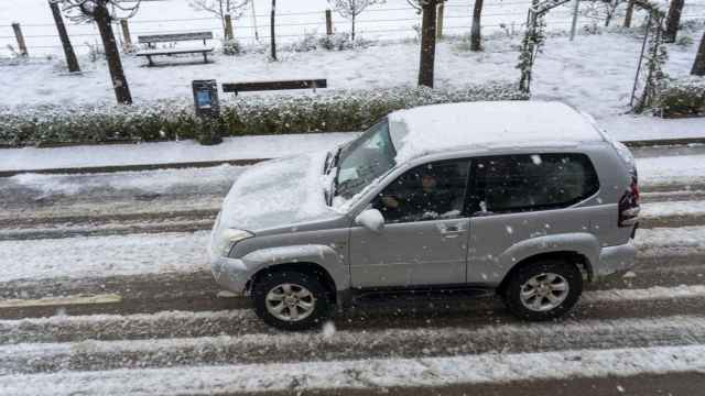 Un coche circulando con nieve.