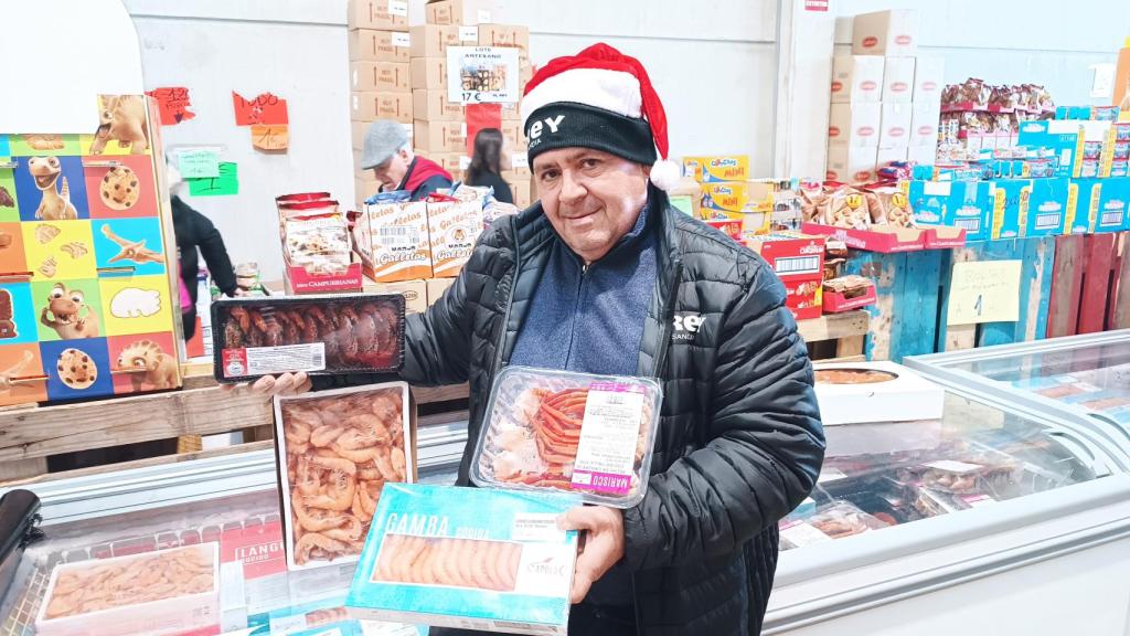 Carlos Moreno, posando con las cajas de marisco que tiene de oferta de cara a Navidad.