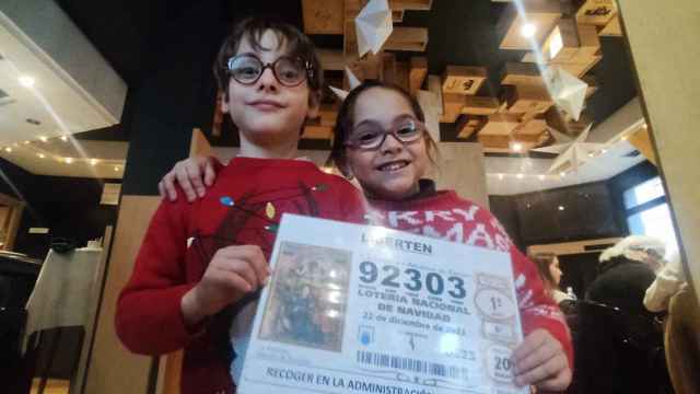 Naia Cabrero con el número elegido esta Navidad, que ha repartido 55.000 euros; junto a su amigo del cole Gonzalo