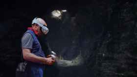 Un fotomontaje con un hombre usando un equipo de realidad virtual en una de las cuevas recreadas por Murciélagos Málaga.