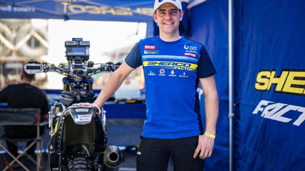 Lorenzo Santolino junto a su moto en el garaje de Sherco
