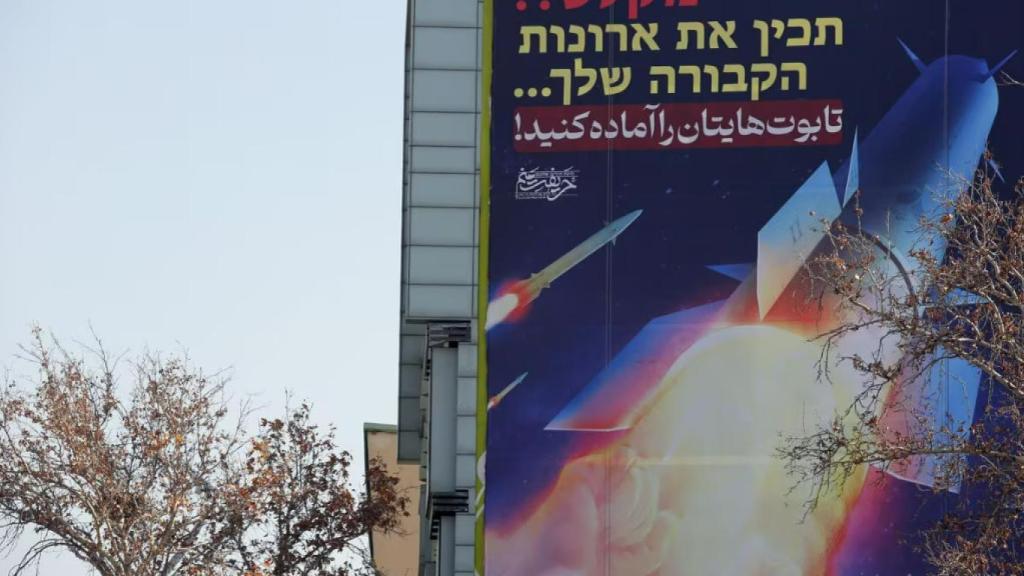 Una valla que muestra misiles iraníes un edificio en la plaza Palestina de Teherán.