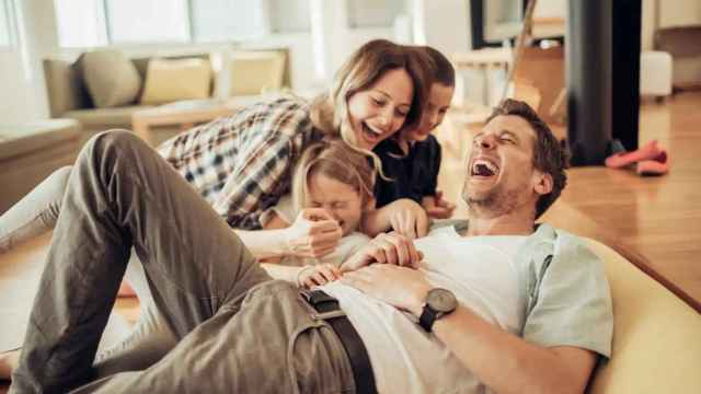 Imagen de archivo de una familia riéndose.