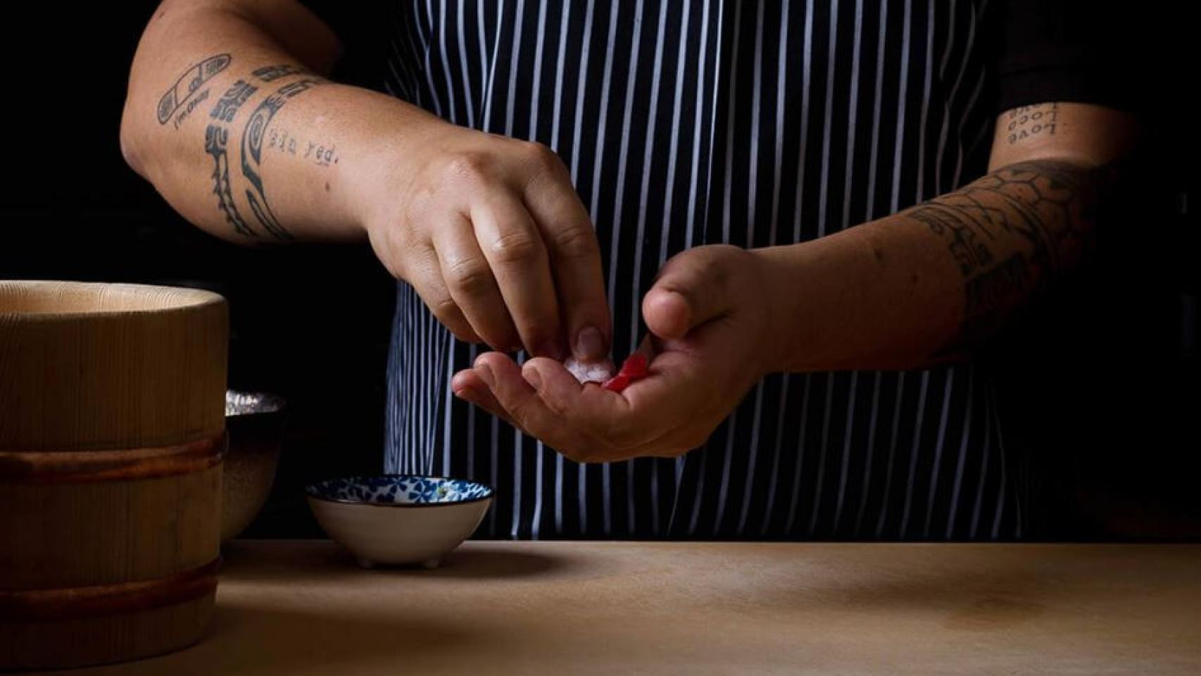 El chef Mario Payán preparando una pieza de sushi en su barra de Kappo.