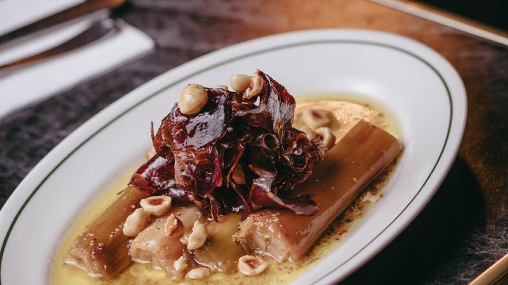 Su plato de puerros escalivados con cecina y avellanas.