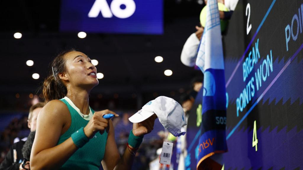 Qinwen Zheng firma autógrafos en el Open de Australia.