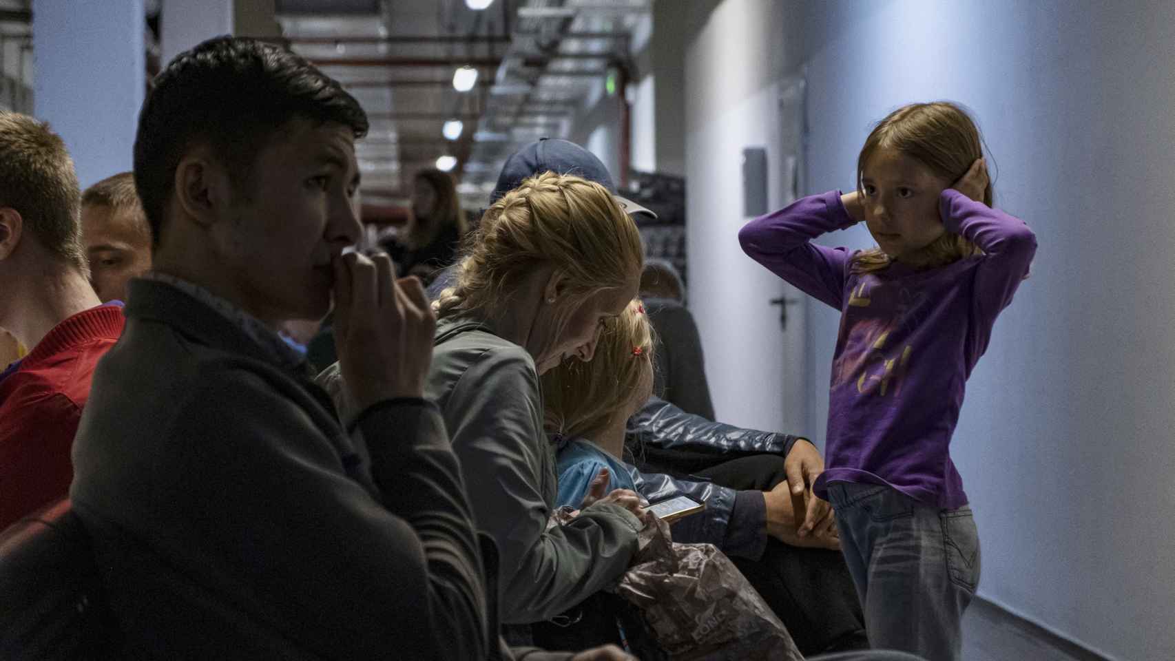 Una niña ucraniana se tapa los oídos en el refugio de un centro comercial cuando las sirenas antiaéreas vuelven a sonar.