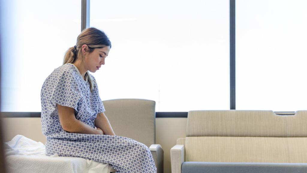 Una paciente preocupada en la camilla de un hospital.