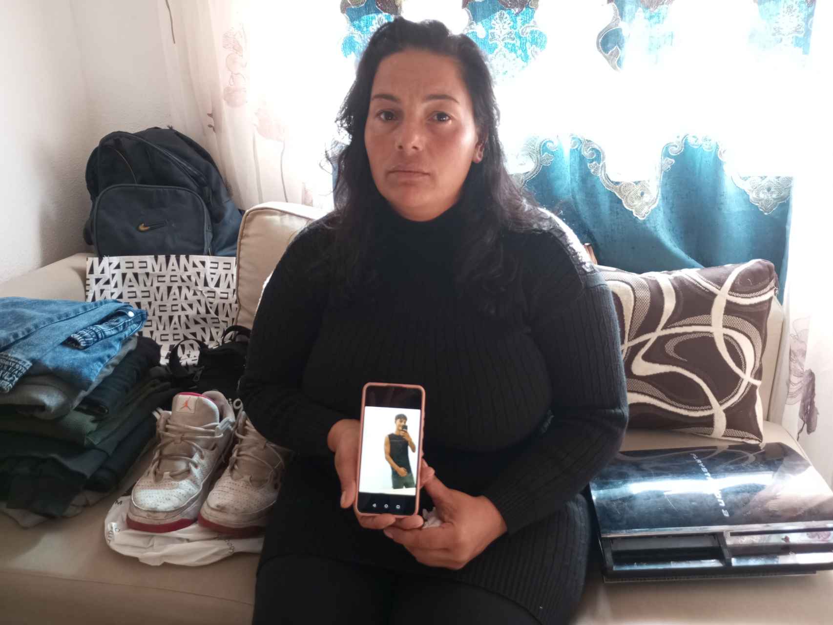 Miglena Petrova, la madre del difunto Ivo, mostrando una foto de su hijo en la habitación de su casa en Los Alcázares.