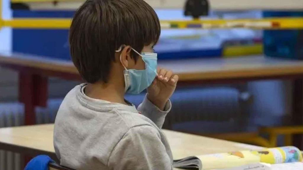 Un niño con mascarilla en la escuela.