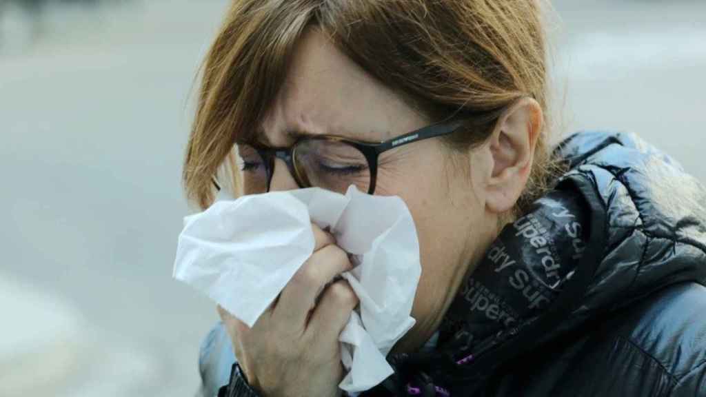 Imagen de archivo de una mujer estornudando por los efectos de la alergia.