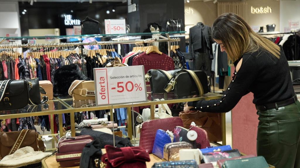 Una mujer observa un bolso, en los primeros minutos de rebajas, en El Corte Inglés de la calle Preciados.