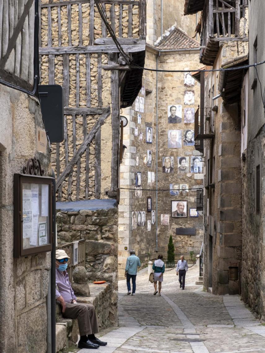 Una de las calles de Mogarraz, con algunos de los retratos al fondo