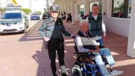 Dos hombres de la Guardia Civil con Paco, el dueño de la silla de ruedas.