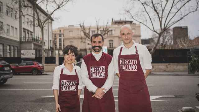 Lucia Pares, Salvatore Gambitta y Giacomo Tavernaro, camareros de un comercio italiano situado frente a la Scuola Italiana de Madrid, al fondo.
