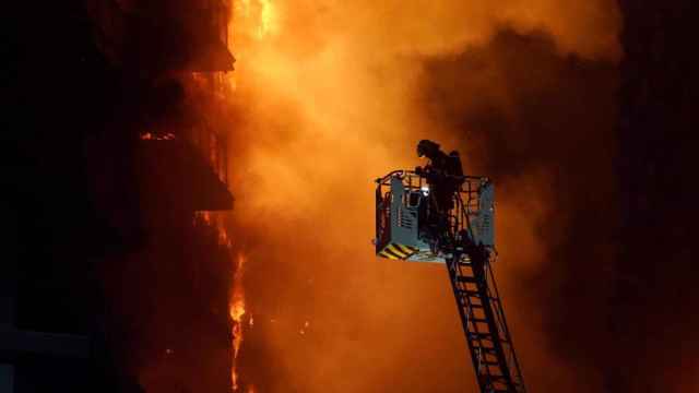 Un bombero trabajando en el edificio incendiado en Valencia.