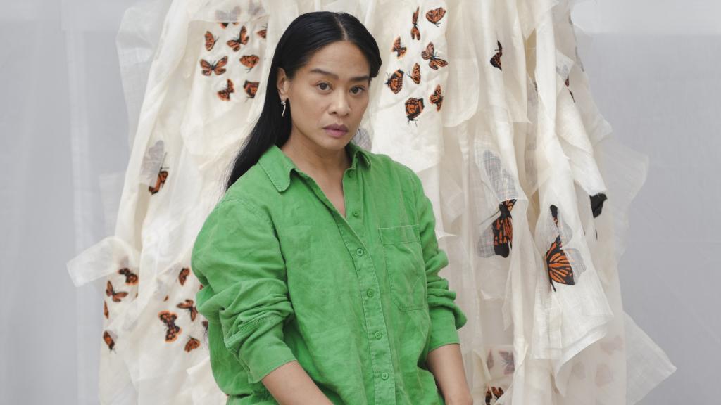 La artista canadiense Stephanie Comilang junto a dos de las piezas de su montaje.