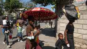 Habitantes caminan por una calle este sábado en Puerto Príncipe (Haití).