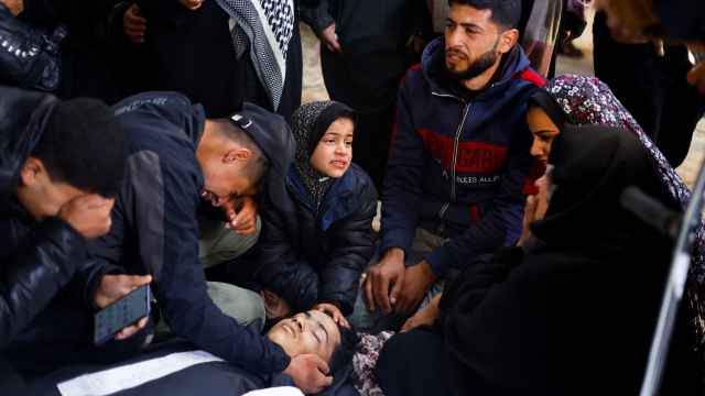 Un grupo de palestinos rodean el cuerpo de un joven fallecido por los bombardeos israelíes al sur de la Franja de Gaza.