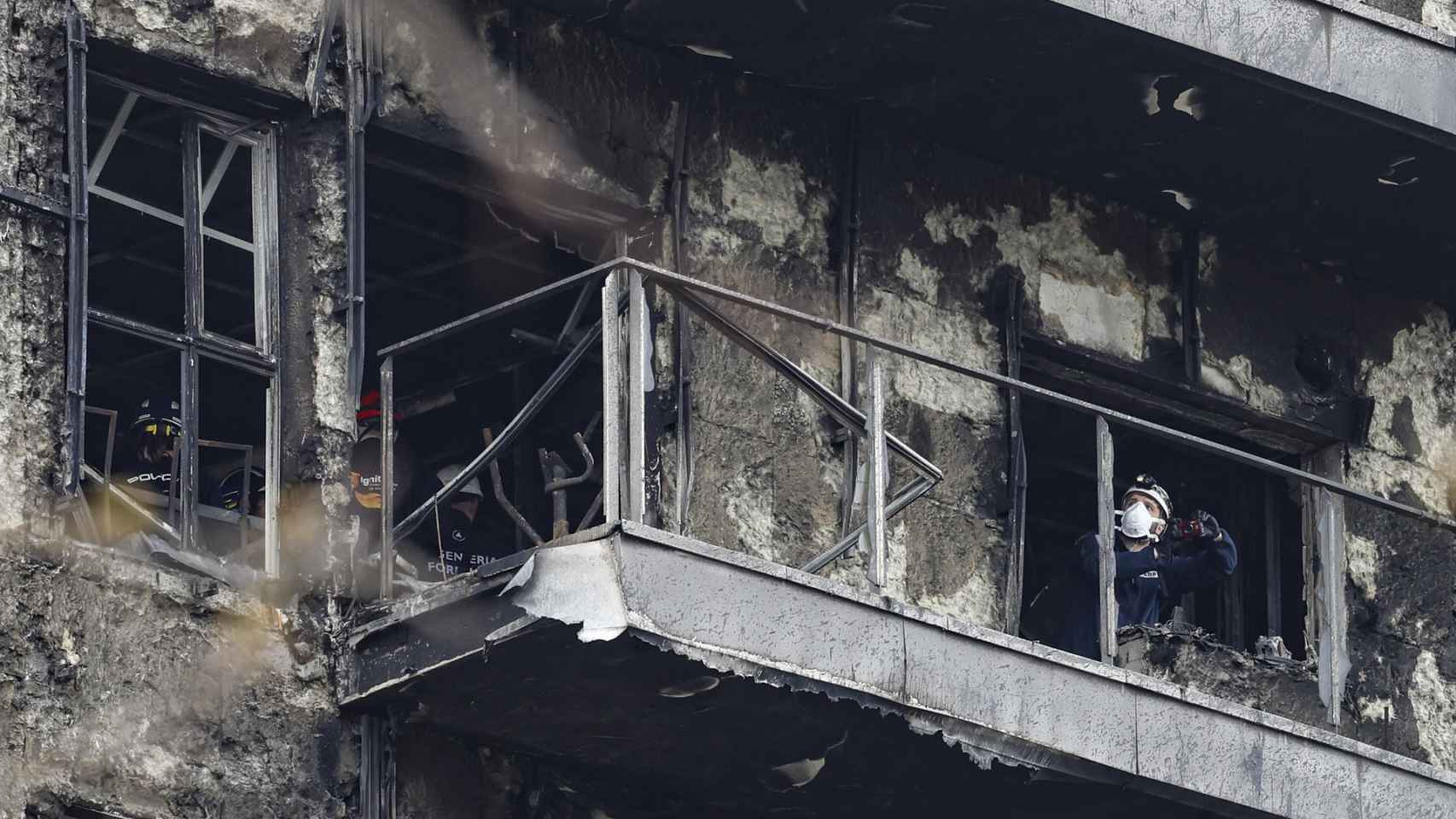 Peritos inspeccionando desde el interior los daños del edificio incendiado en Campanar.