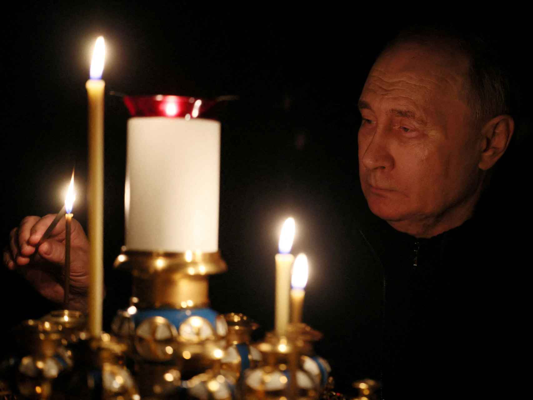 Vladimir Putin enciende una vela durante el acto de homenaje a las víctimas del atentado en Moscú