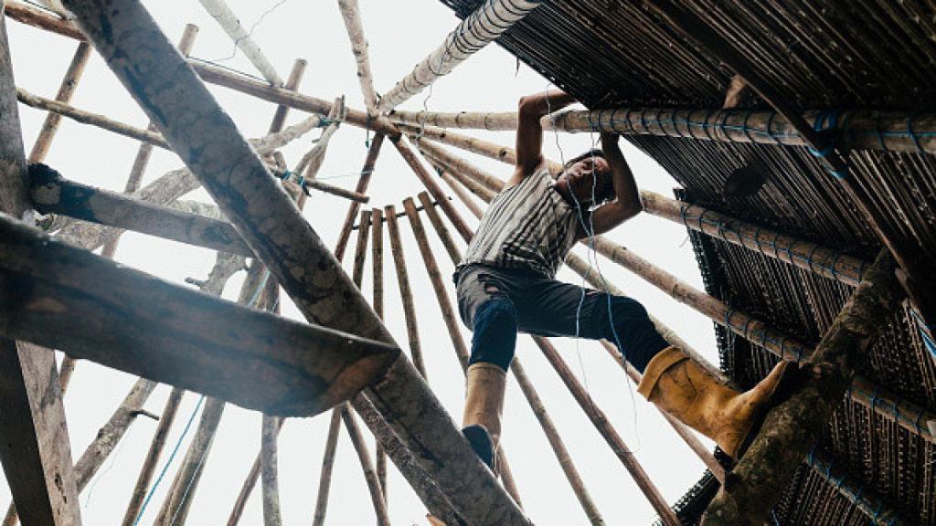 Los miembros de la familia Pinchu de Wichimi construyen su cocina utilizando una técnica tradicional en la que el techo está hecho de hojas.
