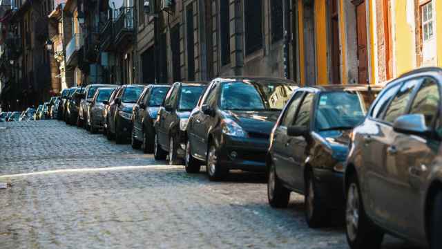 Varios coches aparcados en el centro de una ciudad.