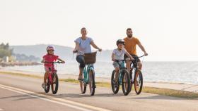 Dos niños y dos adultos montando en bicicleta